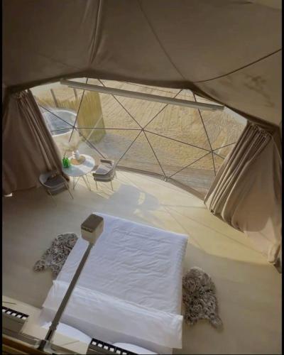 a view of a tent with a bed in it at Rina Luxury Camp in Wadi Rum