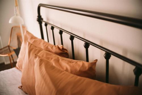 a black bed with a pillow on it at Object Hotel 1BR Shared Bath Room 2D in Bisbee