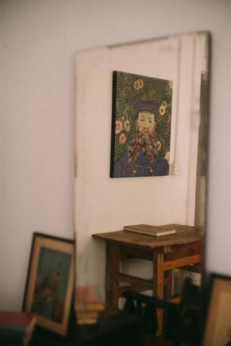 a painting of a boy on a wall with a table at Object Hotel 1BR Shared Bath Room 2D in Bisbee