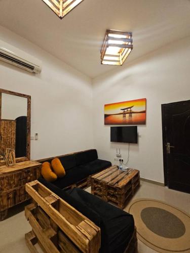 a living room with a couch and a table at Black Moon Studio jimi in Al Ain
