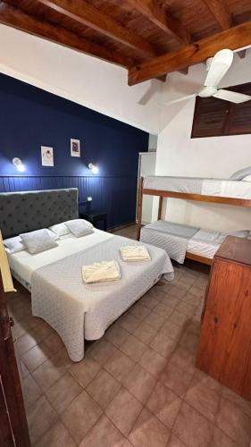 a bedroom with two beds and two bunk beds at Hotel Garay in San Bernardo