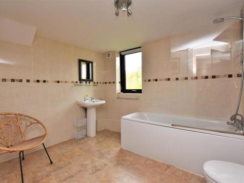 a bathroom with a tub and a sink and a toilet at 2 Bed in Holmesfield oc-pk783 in Dronfield