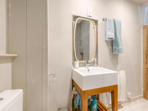 a bathroom with a white sink and a mirror at 2 Bed in Fowey oc-91396 in Fowey