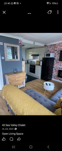 a living room with a couch and a kitchen at 43 sea valley in Bideford