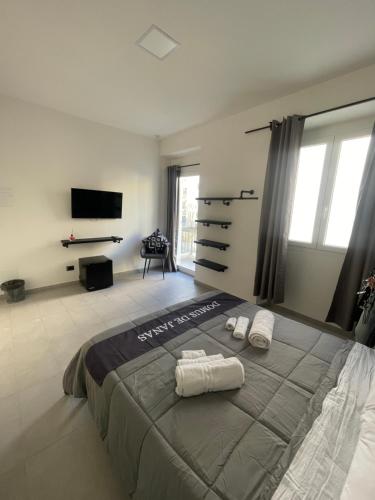 a bedroom with a bed with two towels on it at Domus de janas 2 in Alghero