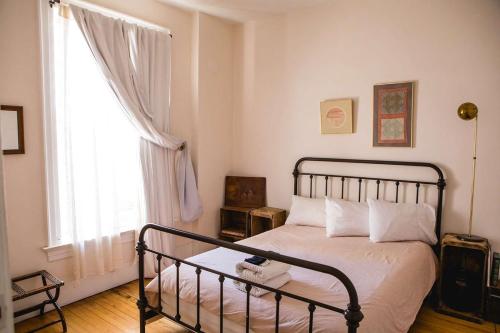 a bedroom with a bed and a large window at Object Hotel 2BR Room 2G in Bisbee