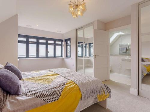 a bedroom with a bed and a chandelier at 3 Bed in Hythe oc-87167 in Hythe