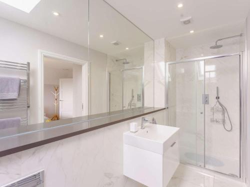 a white bathroom with a sink and a shower at 3 Bed in Hythe oc-87167 in Hythe