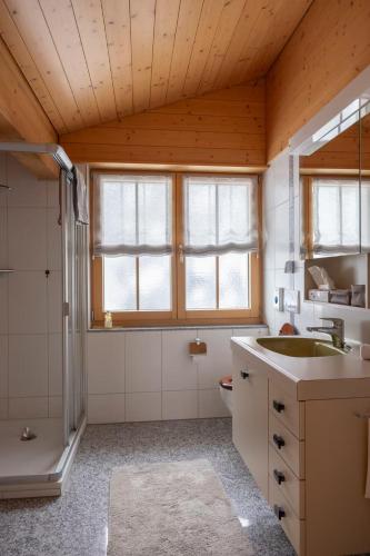 a bathroom with a sink and a shower and a toilet at Chalet Gutsch Andermatt in Andermatt