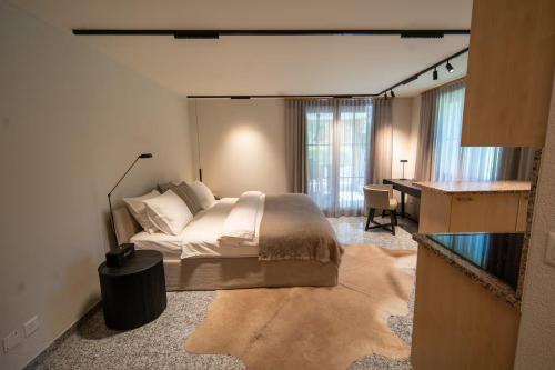 a bedroom with a bed and a desk in it at Chalet Gutsch Andermatt in Andermatt