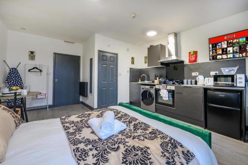 a large kitchen with a bed in a room at 78F3 - Cosy & Welcoming studio in Bradford