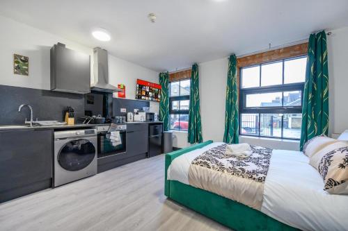 a kitchen and a bedroom with a bed in a room at 78F3 - Cosy & Welcoming studio in Bradford