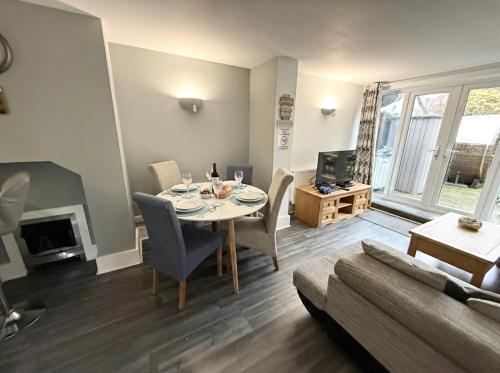 a living room with a table and a couch at Bournemouth Hot Tub & Sauna Holiday Let in Bournemouth