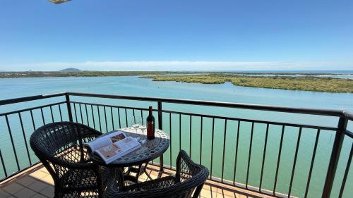 a table with a bottle of wine on a balcony at Banyandah Towers in Maroochydore