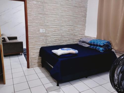 a room with a bed and a chair in it at casa 1 perto do pavilhão de Carapina a 8 kilometros do aeroporto in Serra