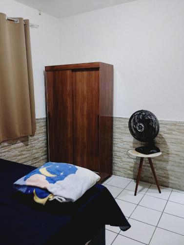 a bedroom with a bed and a chair in it at casa 1 perto do pavilhão de Carapina a 8 kilometros do aeroporto in Serra