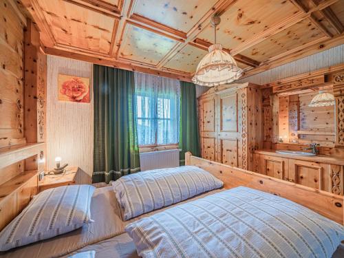 a bedroom with a bed in a room with wooden walls at Poschen in Wald im Pinzgau