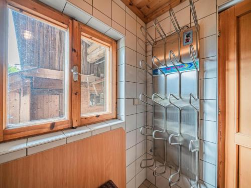 a kitchen with a window and utensils at Poschen in Wald im Pinzgau