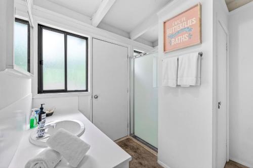 a white bathroom with a sink and a shower at Oceanside Escape in Aireys Inlet