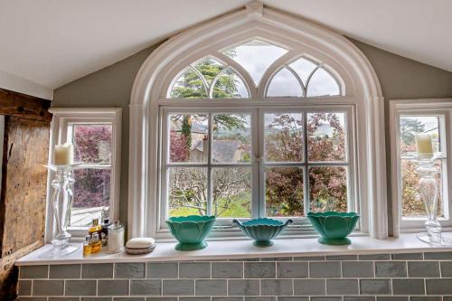a kitchen window with three green bowls on a counter at 3 Bed in Ruthin oc-a29313 in Ruthin