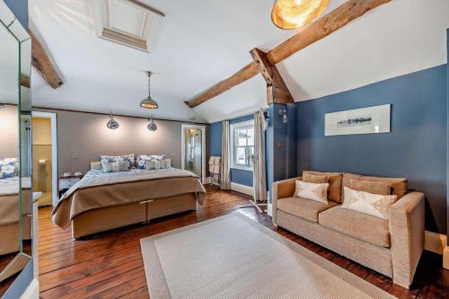 a bedroom with a bed and a couch at 3 Bed in Ruthin oc-a29313 in Ruthin