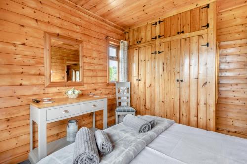 a bedroom with a bed in a wooden cabin at 2 Bed in Somerton oc-w29203 in Somerton