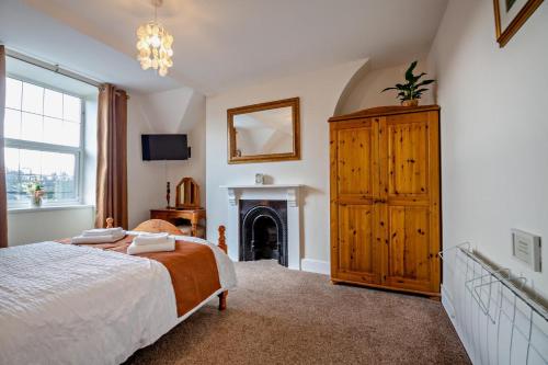 a bedroom with a bed and a fireplace at 3 Bed in Llanbedr oc-t28932 in Llanbedr