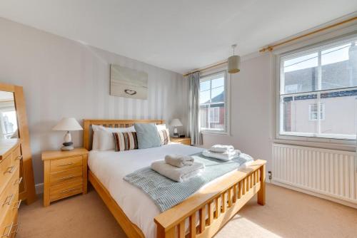 a bedroom with a large bed with towels on it at 4 Bed in Southwold oc-ivy in Southwold
