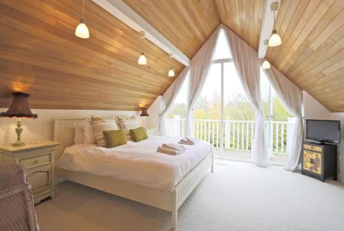 a bedroom with a bed and a large window at 3 Bed in Ufford oc-sfmea in Ufford