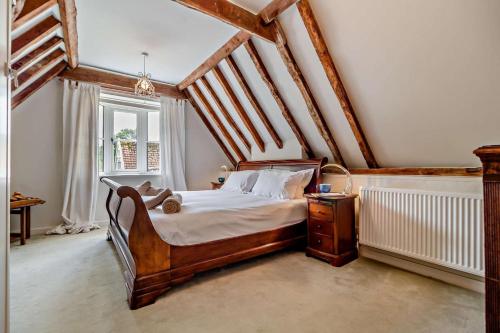 a bedroom with a wooden bed and a window at 3 Bed in Snape oc-g29478 in Snape