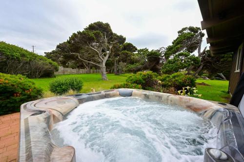 a hot tub in a backyard with a garden at Dream Scape in Fort Bragg