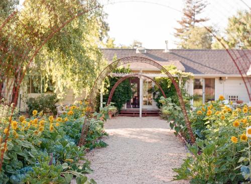 an archway in a garden in front of a house at Napa Farmhouse Inn in St. Helena