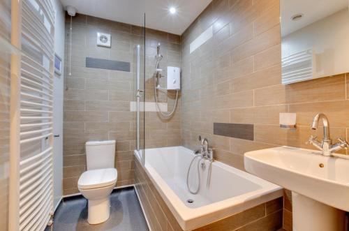 a bathroom with a toilet and a sink and a shower at 3 Bed in Thornham oc-983 in Thornham
