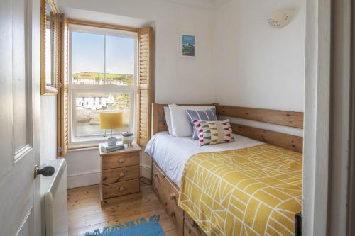 a small bedroom with a bed and a window at 3 Bed in Porthleven oc-12bayv in Porthleven