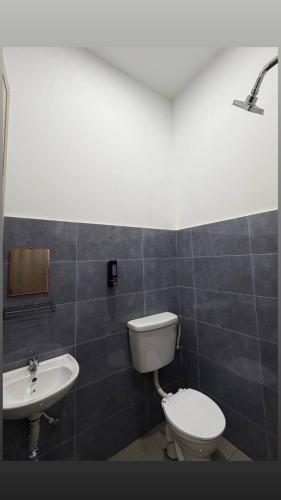 a bathroom with a toilet and a sink at Homestay Aydan at Kijal Kemaman in Cukai