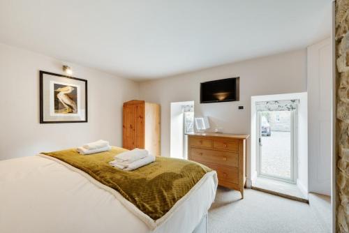 a bedroom with a bed and a dresser and a television at 2 Bed in Danby oc-wa315 in Castleton