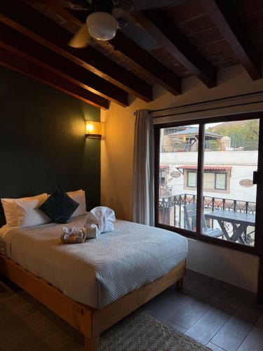 a bedroom with a bed and a large window at Hotel las Orquideas in Valle de Bravo