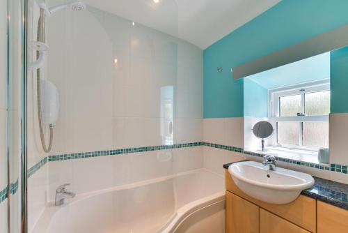 a bathroom with a tub and a sink and a shower at 2 Bed in Thwaite oc-ds946 in Thwaite