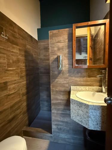a bathroom with a sink and a mirror at Hotel las Orquideas in Valle de Bravo