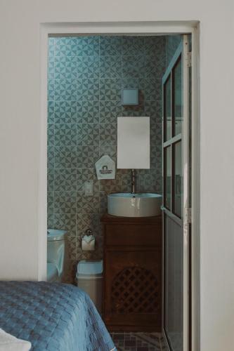 a bedroom with a sink and a bathroom with a toilet at Casa Arcos Tepoztlán in Tepoztlán