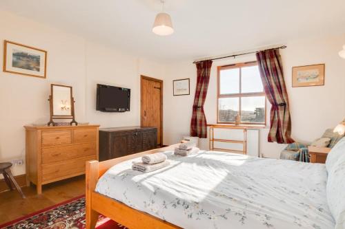a bedroom with a bed and a tv and a window at 2 Bed in Chatton oc-nb620 in Chatton