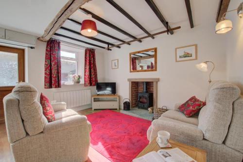a living room with two couches and a red rug at 2 Bed in Gayle oc-ds912 in Hawes