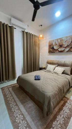 a bedroom with a large bed in a room at Paradise Homestay Marang in Marang