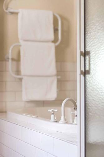 a bathroom with a mirror and white towels at Mountainside Villa One in Halls Gap