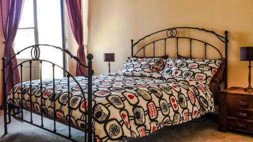 a bedroom with a bed with a patterned comforter at Anduma Bin in Turin