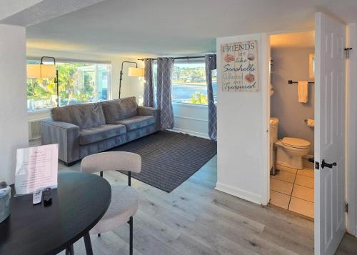 a living room with a couch and a table at Oasis Palms Resort in St. Pete Beach