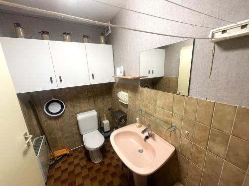 a bathroom with a sink and a toilet at Apartment with Pool and Sea View in Middelkerke