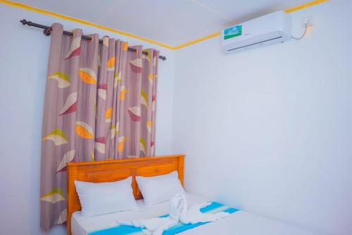 a bedroom with a bed with a curtain at Ceylon Retreat Villa in Kamburugamuwa