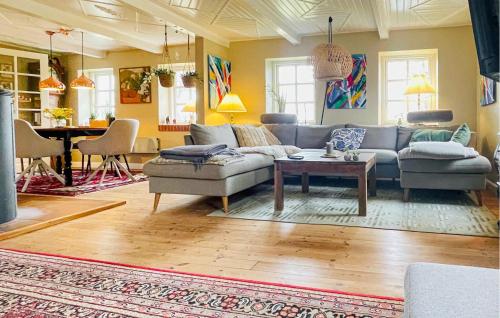a living room with a couch and a table at Amazing Home In Ulfborg With Kitchen in Ulfborg
