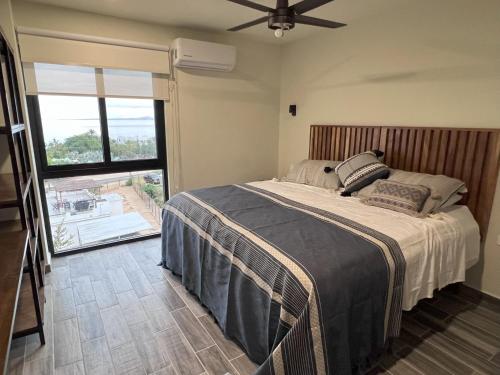 a bedroom with a bed and a large window at Ventonorte in La Ventana